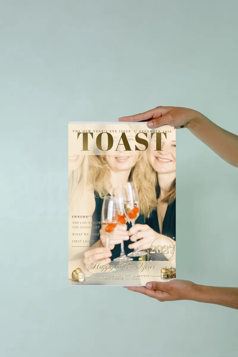 Two hands holding the Champagne Toast magazine cover print, headlined Toast